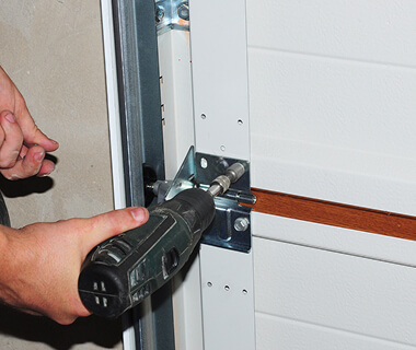 Technician repairing garage door operator